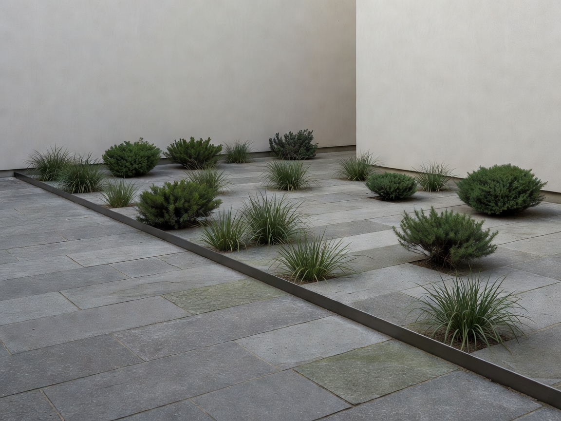 Stone paving, restrained planting and a metal edge in a sheltered courtyard